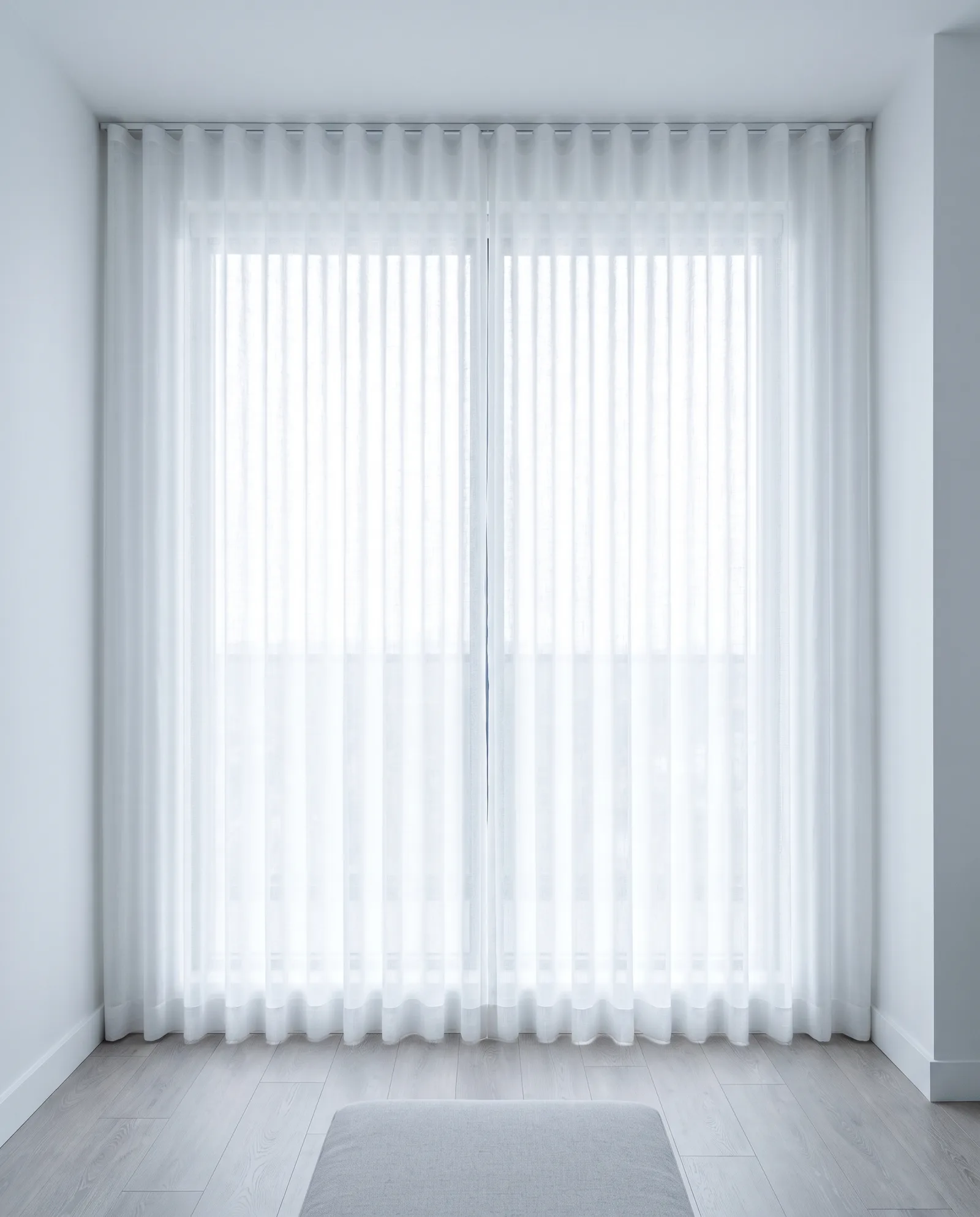 White wave-fold sheer curtains diffusing daylight